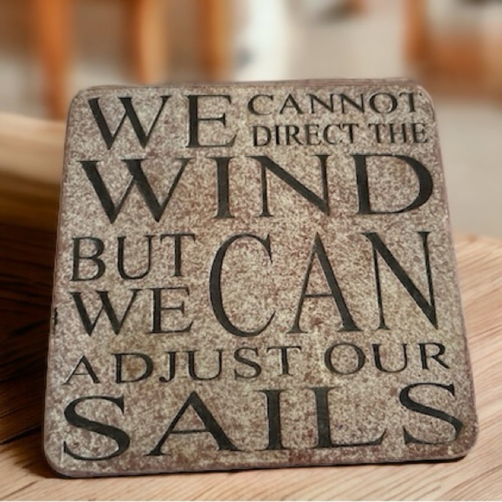 Wall hanging or coaster. We cannot direct the wind but we can adjust our sails.